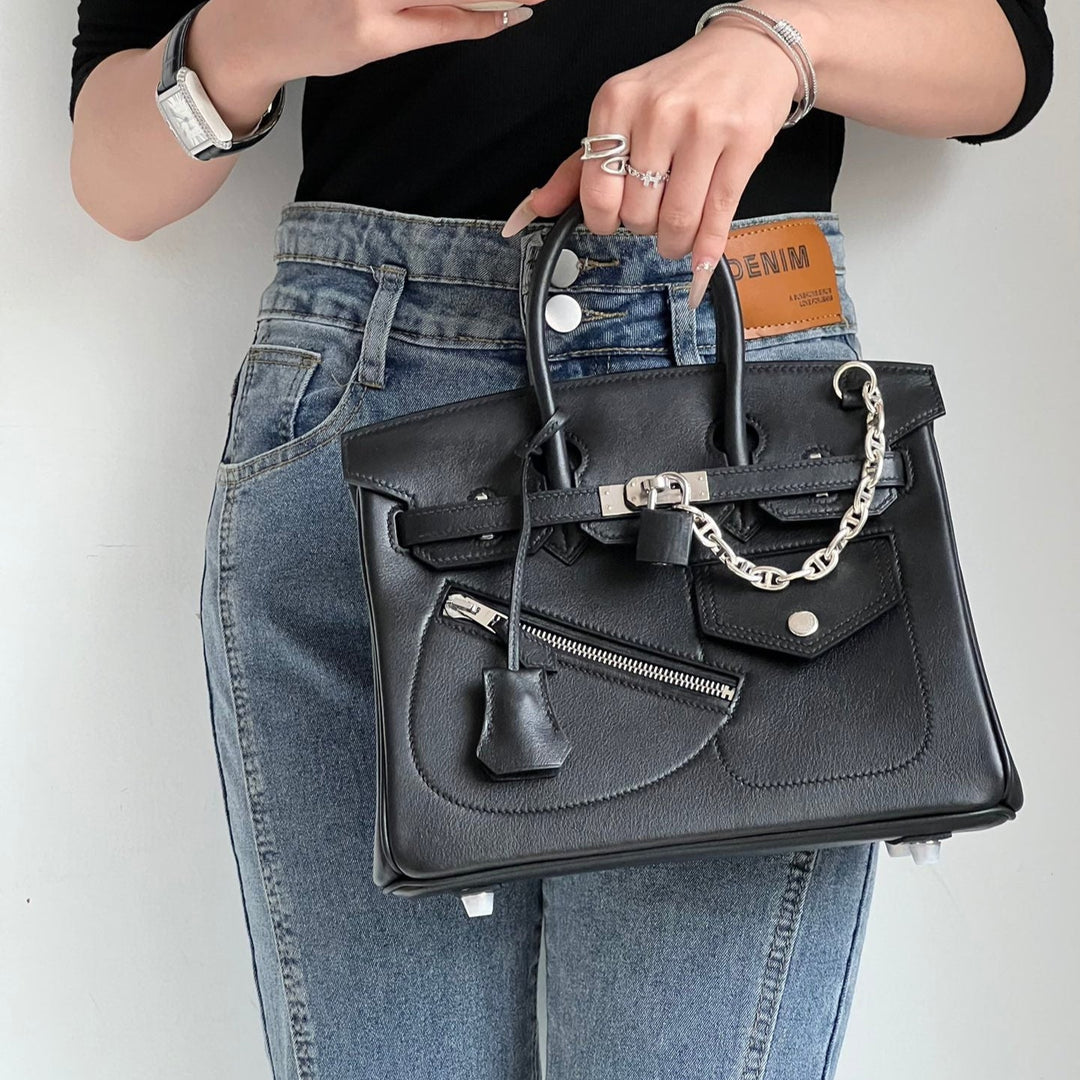 Women's full-grain leather handbag with padlock clasp and chain