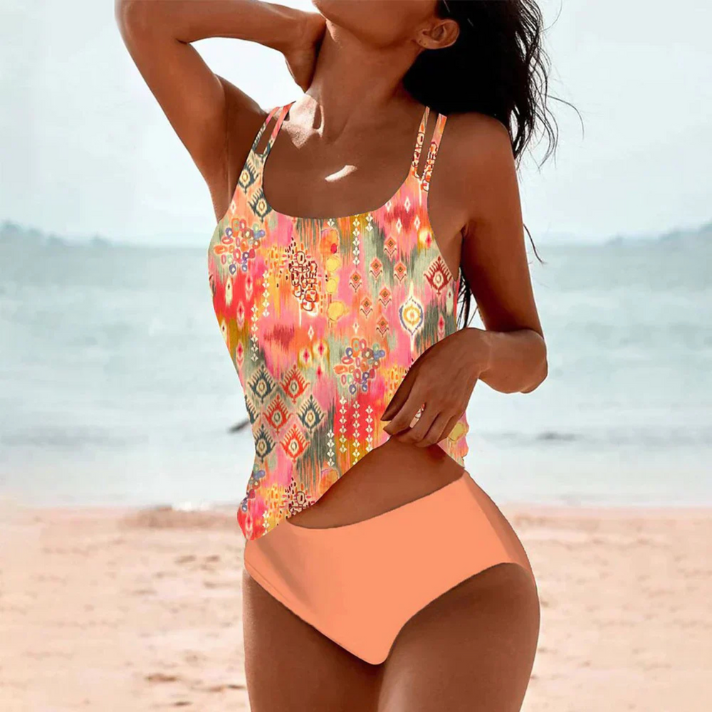 Maillot de bain Alizée pour femme, moderne et coloré. Ce modèle à motif floral et géométrique vibrant avec des couleurs chaudes comme le rose, l'orange et le jaune est parfait pour se détendre à la plage. Avec son design chic et sa coupe flatteuse, il offre à la fois confort et style pour vos moments ensoleillés.