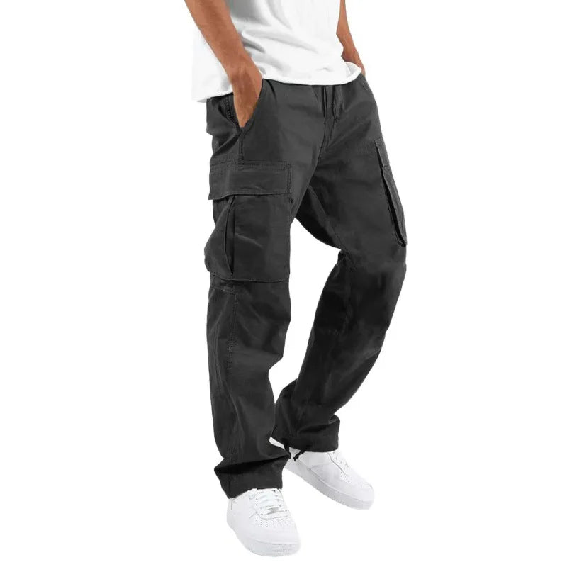 Homme portant le pantalon droit Aymeric pour hommes, style cargo noir avec poches latérales spacieuses, coupe droite confortable et bas ajustables, porté avec un t-shirt blanc et des baskets blanches  style tendance et décontracté.