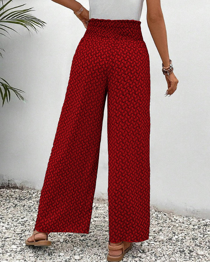pantalon à coupe large avec taille élastiquée et motif géométrique rouge, vue arrière montrant la coupe fluide et élégante, parfait pour une tenue moderne et décontractée.