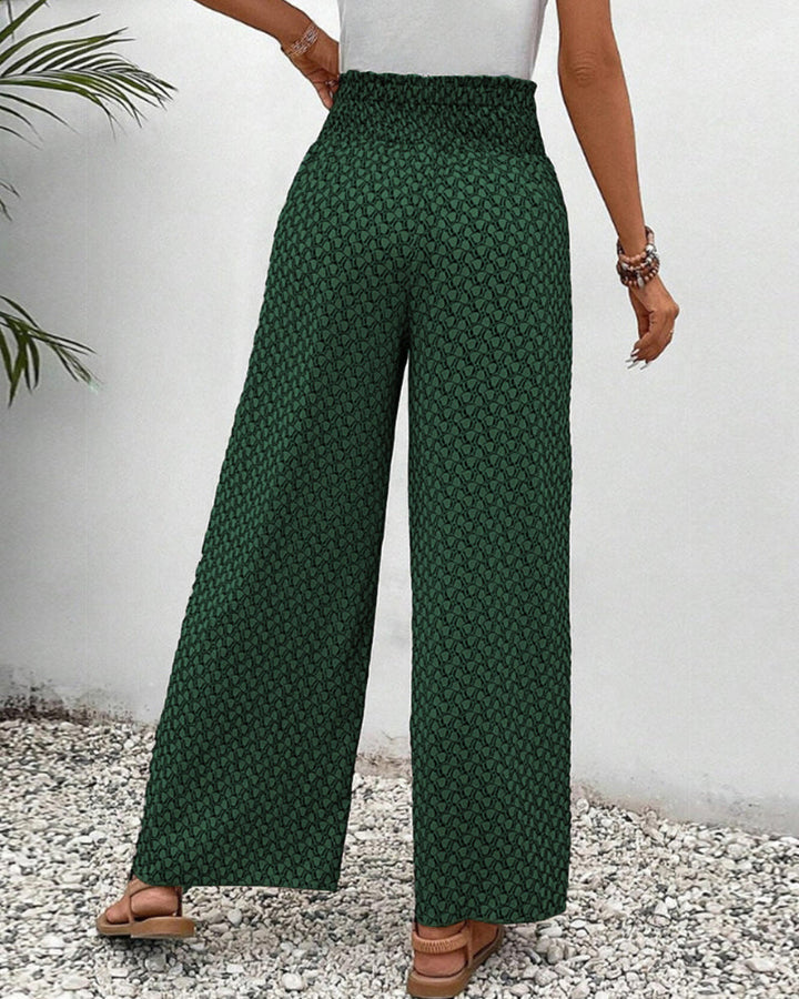 pantalon à coupe large avec taille élastiquée et motif géométrique vert, vue arrière montrant la coupe fluide et élégante, idéal pour un look décontracté et moderne.