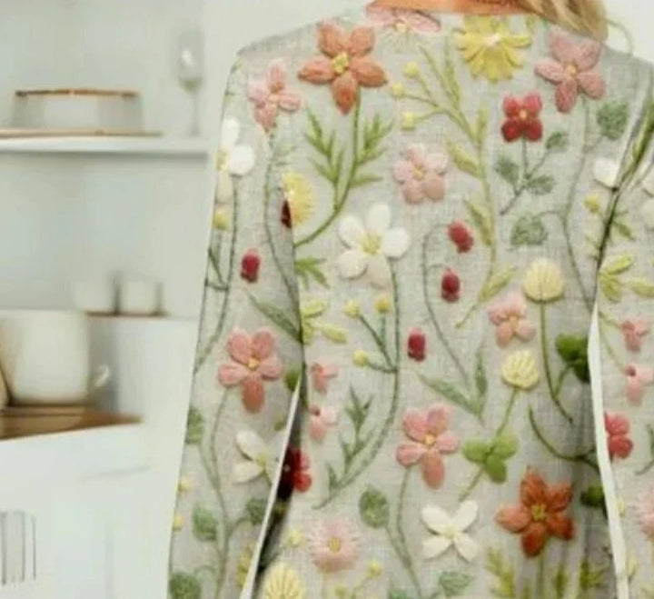 Vue de dos du pull à manches longues avec imprimé floral multicolore et finitions en relief, style printemps.