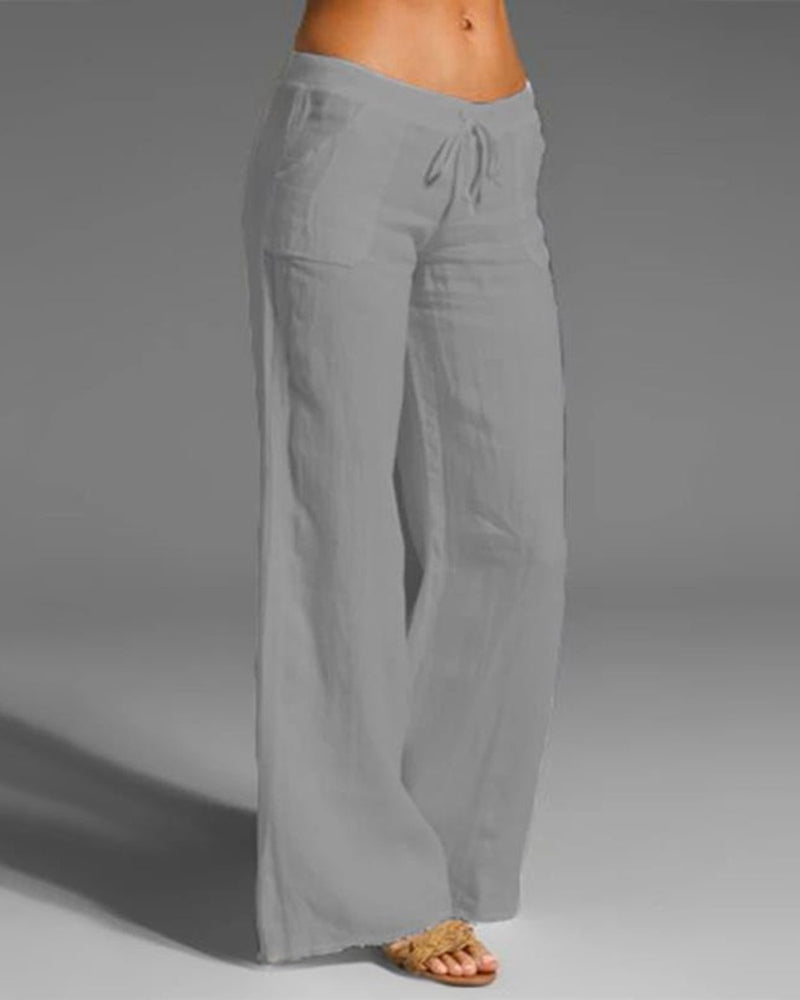 Pantalon large femme gris, coupe fluide à jambes évasées avec taille élastique et cordon de serrage, tissu léger et agréable à porter  look tendance et décontracté.