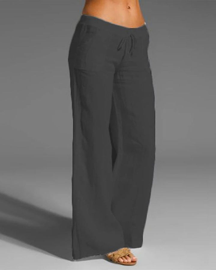 Pantalon large femme noir, coupe fluide à jambes évasées avec taille élastique et cordon de serrage, tissu léger et respirant  look tendance et décontracté.