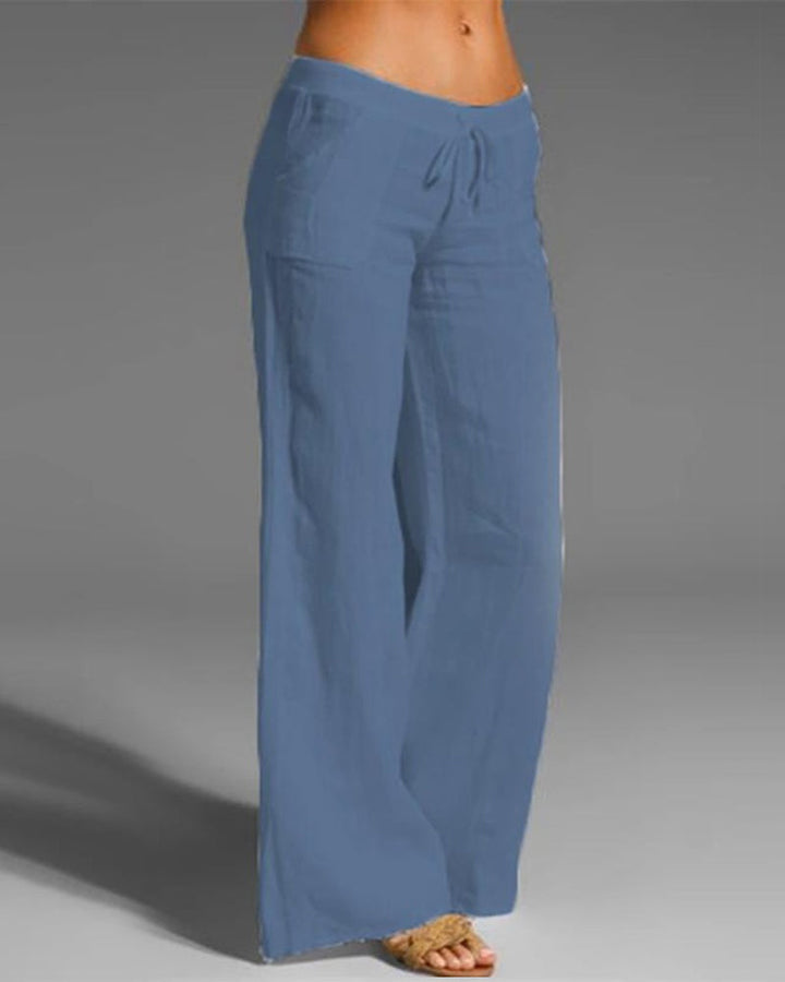 Pantalon large femme bleu clair, coupe fluide à jambes évasées avec taille élastique et cordon de serrage, tissu léger et agréable style tendance et estival.