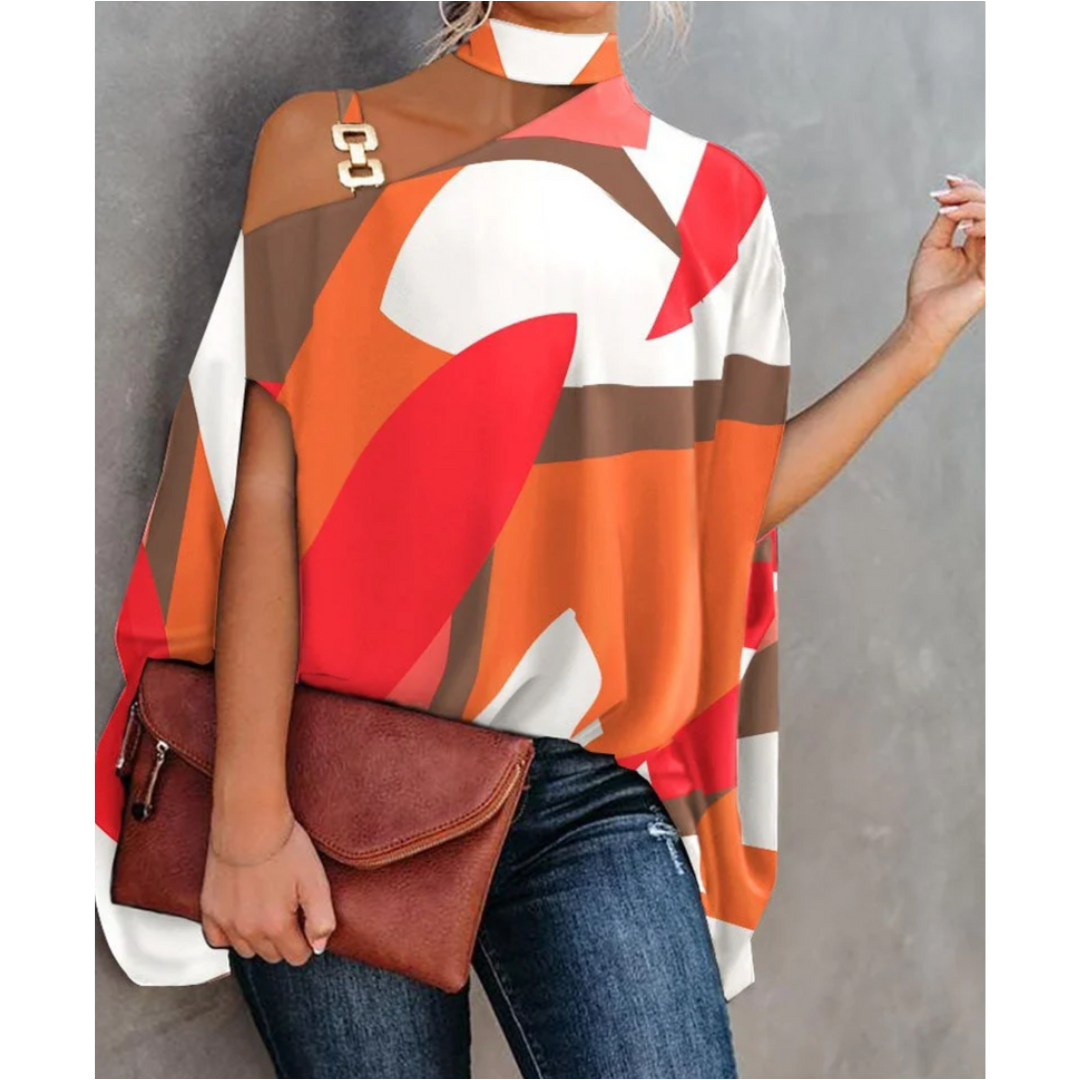 top asymétrique à une épaule avec motifs géométriques dans des tons de rouge, orange, brun et blanc, orné d'un détail en chaîne dorée, parfait pour un look chic et contemporain.