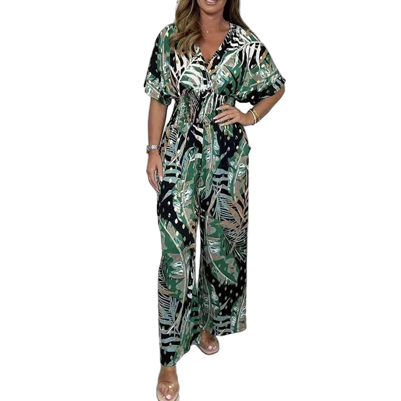 Combinaison imprimée à taille haute et jambes larges pour femme, modèle moderne. Cette combinaison au motif tropical dans des tons de vert, noir et doré offre un look élégant et dynamique. Elle présente une taille élastiquée et des jambes larges, créant une silhouette flatteuse et confortable.