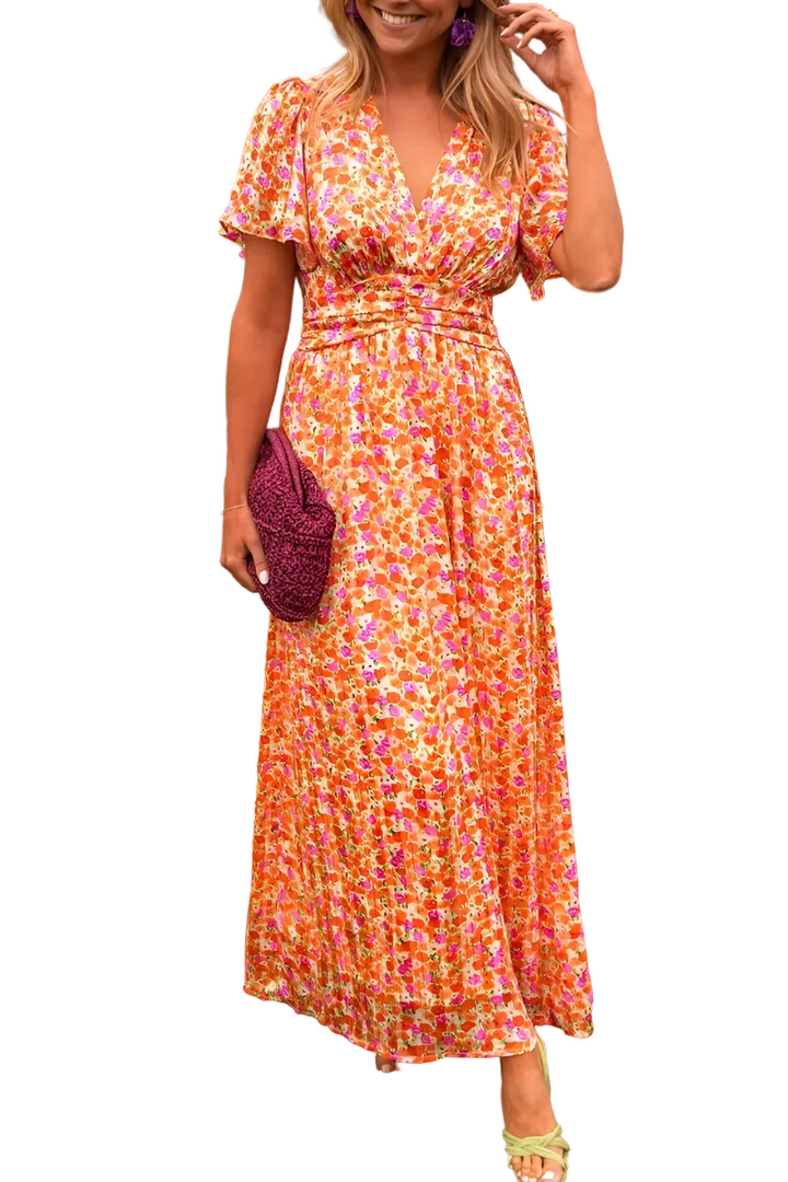 Robe longue à col en V pour femme, modèle tendance. Ce modèle élégant et coloré présente un motif floral vibrant dans des tons de rose, orange et jaune. La robe est complétée par des accessoires modernes, comme un sac en crochet violet et des boucles d'oreilles assorties. Un look parfait pour une occasion estivale, alliant confort et style.