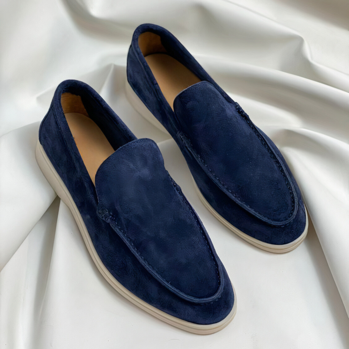 Mocassin élégant pour homme Renaud, tendance et moderne, en suède bleu marine avec des coutures délicates et une semelle légère, offrant un look chic et confortable.
