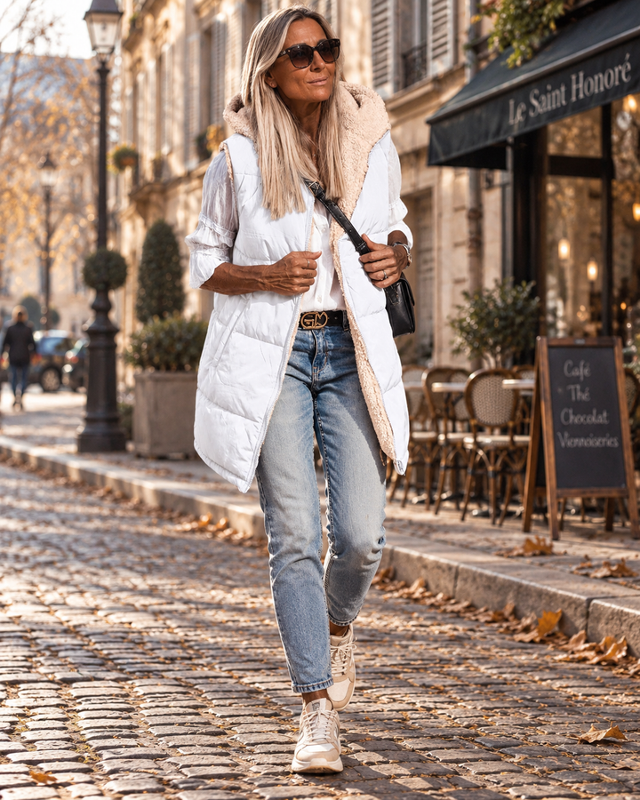 Lange damesbodywarmer - omkeerbaar met sherpavoering en capuchon
