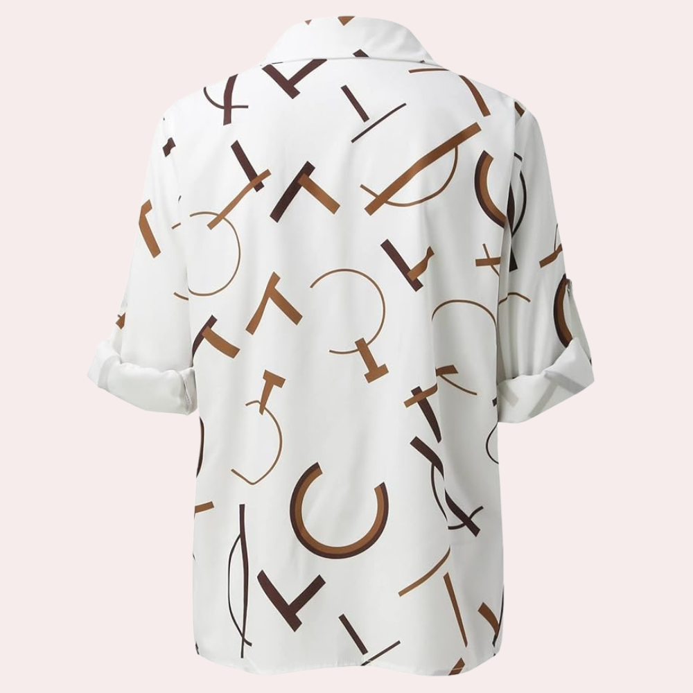 Vue arrière de la chemise femme Xavine blanche avec motif de lettres graphiques marron. Coupe fluide avec manches retroussées, idéale pour un style tendance, moderne et décontracté.