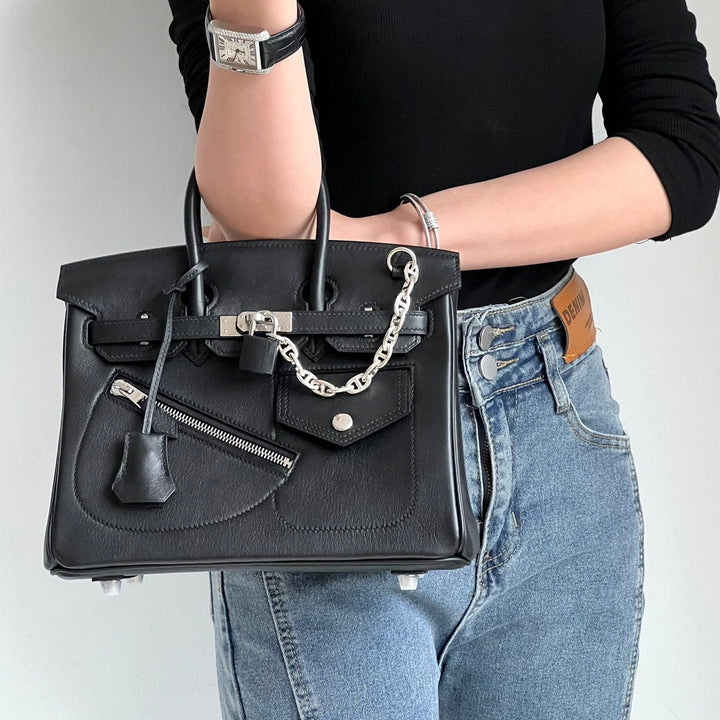 Women's full-grain leather handbag with padlock clasp and chain