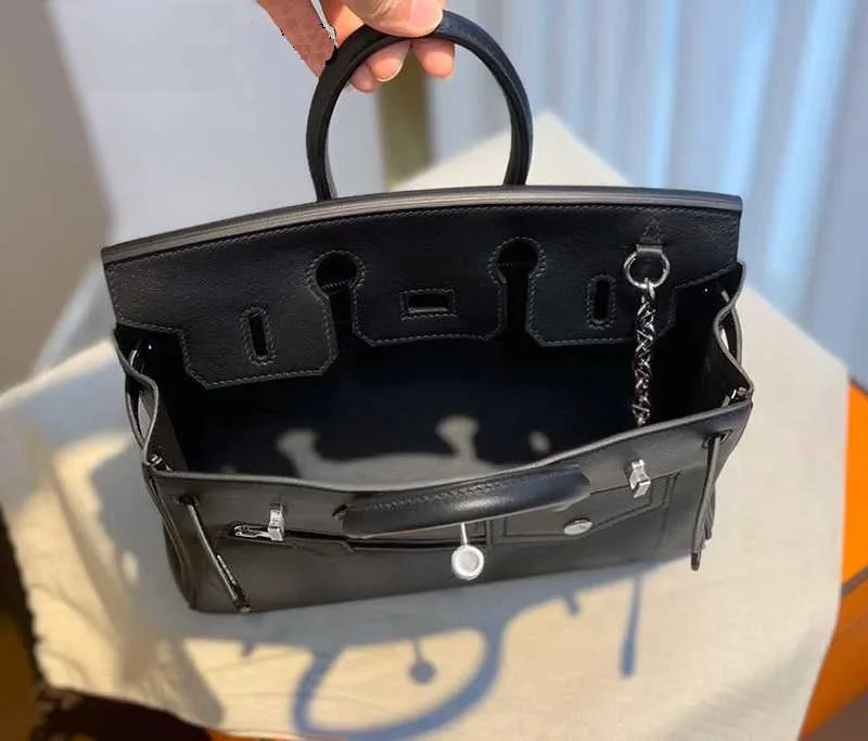 Women's full-grain leather handbag with padlock clasp and chain