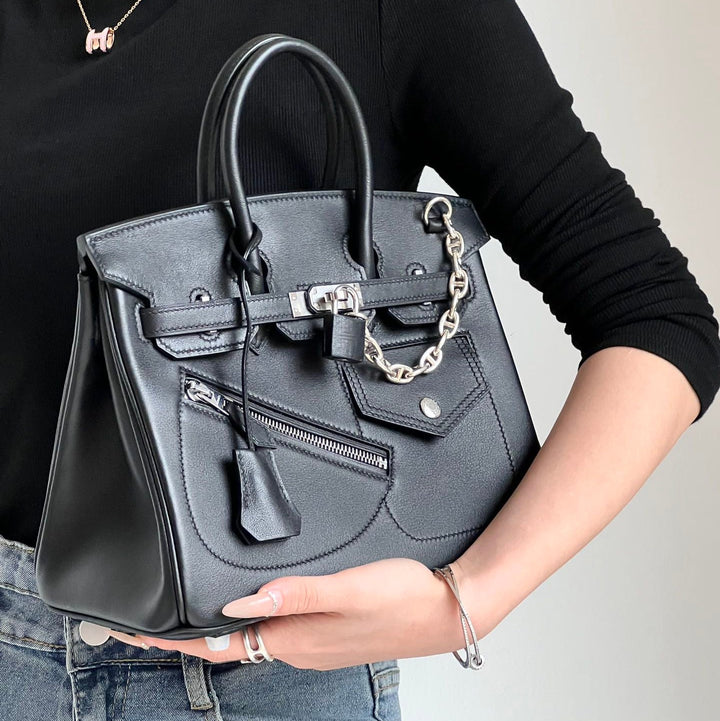Women's full-grain leather handbag with padlock clasp and chain
