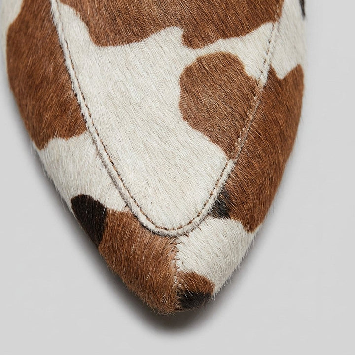 Women's slip-on cow-print mules with a low heel
